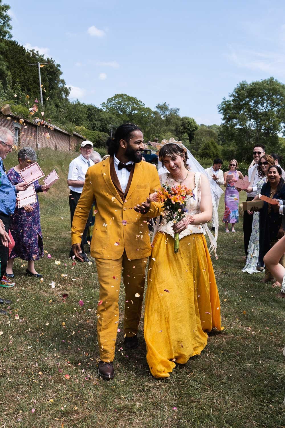 Photography of a yellow DIY wedding in a barn by London photographer Lauren Squire